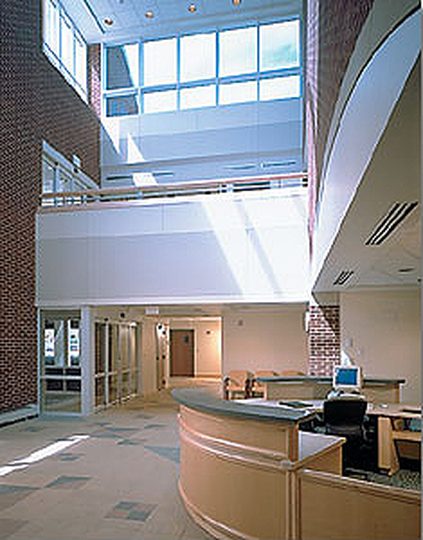 Sunlit atrium with curved reception desk